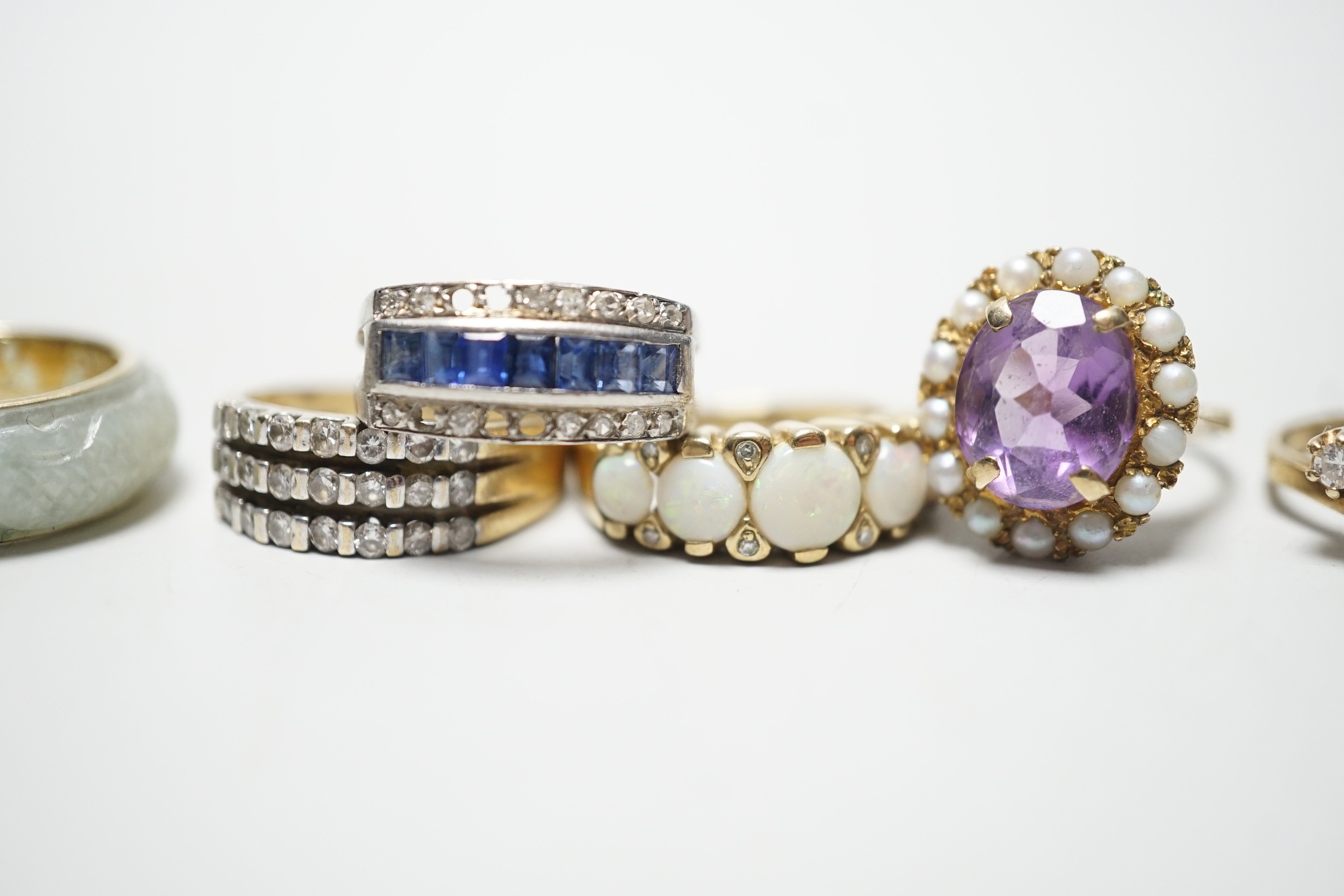 Four assorted modern 9ct god and gem set rings including amethyst and split pearl and white opal and diamond chip, gross 13.5 grams, together with a modern 585 and jade? ring, gross 4.7 grams and a white metal, sapphire